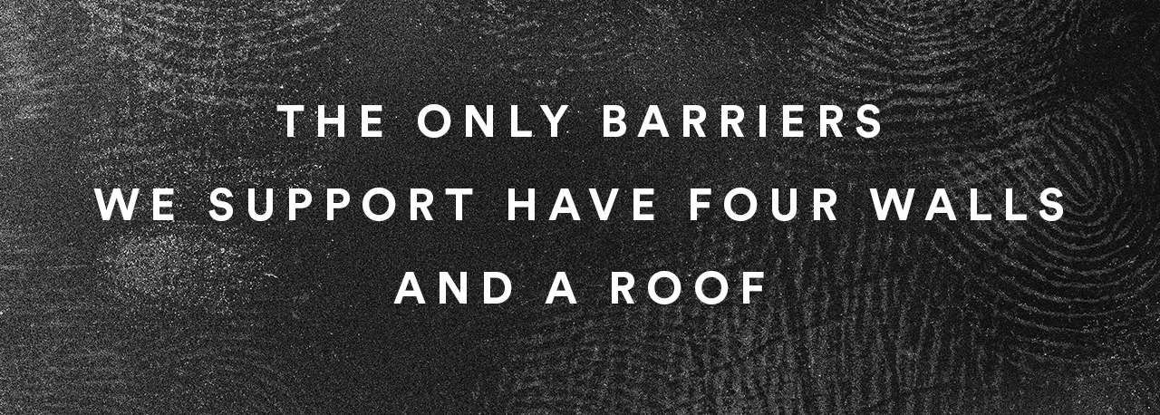  A black background covered in thumbprints with the words ‘The only barriers we support have four walls and a roof’ written in white overtop. 