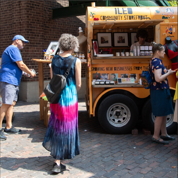 People stand outside an ILEO storefront pop-up in the Distillery District.