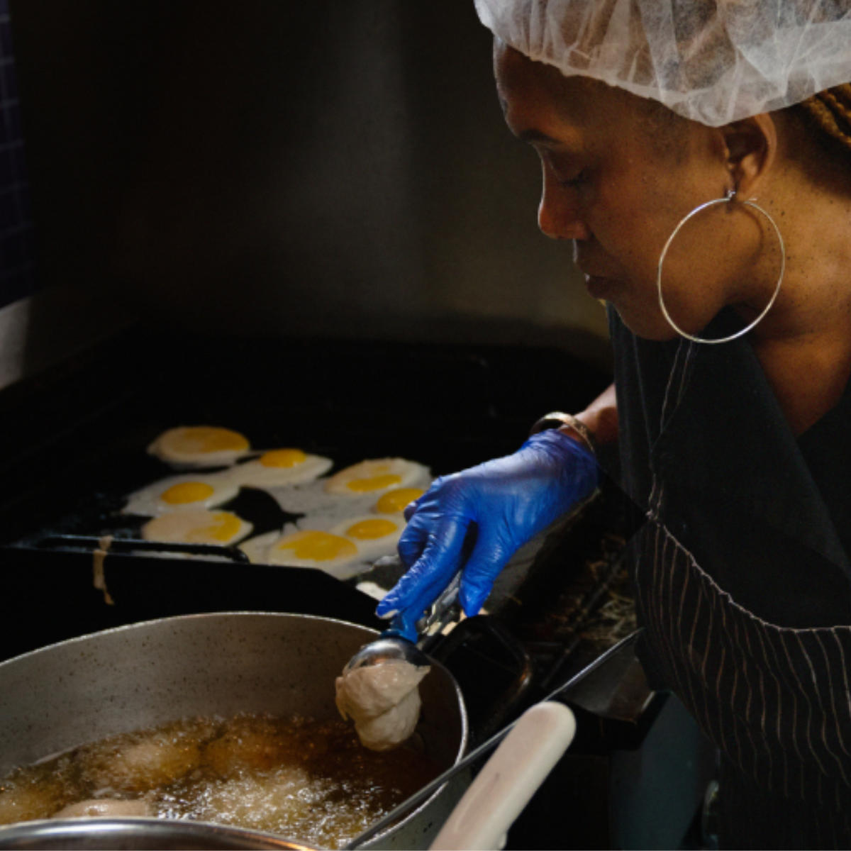 Woman cooking a meal at one of our agencies.