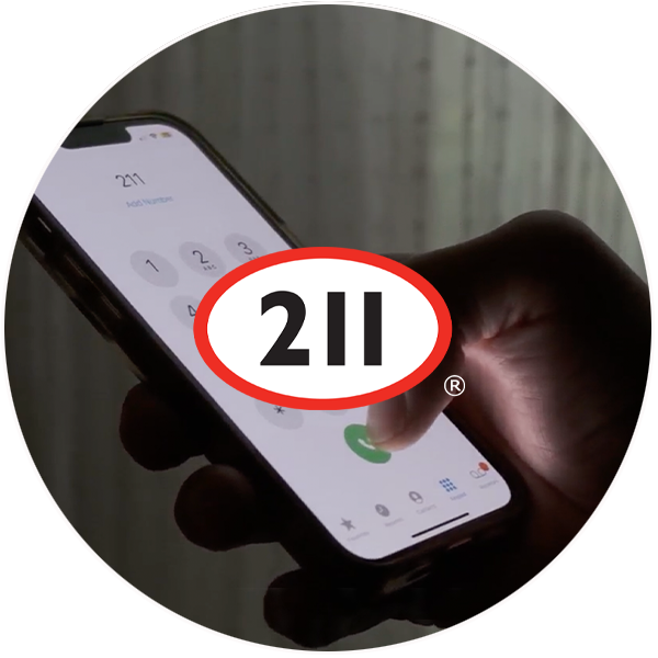 A hand holding a phone, with the 211 logo on top.