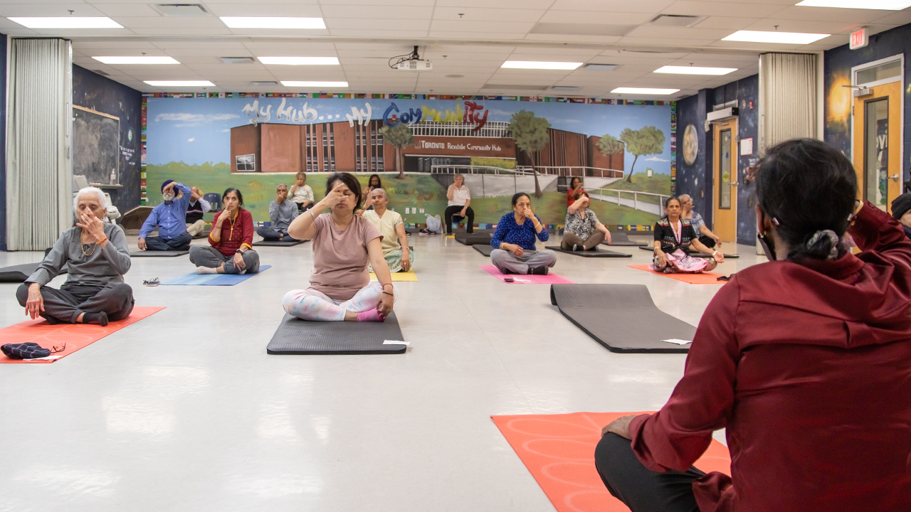 A group of senior citizens take a yoga class at Rexdale Community Hub. 